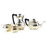 A George V silver four piece tea set, with part fluted body engraved with initials, the coffee pot