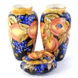 A pair of modern Moorcroft type vases, each decorated with peaches, grapes and leaves, titled