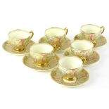 A porcelain part tea service, decorated in green pink and blue and overall gilt decoration,