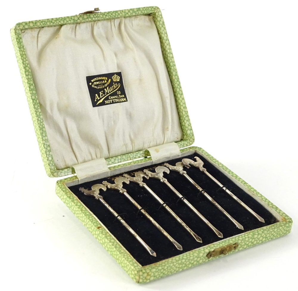 A set of six sterling silver cocktail sticks, each with cockerel handle or finial, retailers case