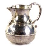 A George V silver cream jug, with moulded and reeded bands, scroll handle, London 1921, 4¼oz.