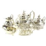 A silver plated three piece tea set, decorated with scrolls, the teapot and sugar bowl with a