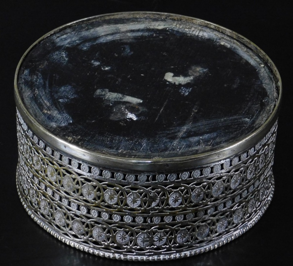 An early 20thC bottle coaster, of circular form, partially pierced and decorated with a repeat - Image 2 of 2