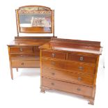 An Edwardian mahogany chest of drawers, with a blind fretwork back rail, and serpentine top, over