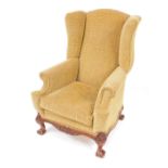 A George III style mahogany wingback armchair, with patterned upholstery, drop in cushion seat,