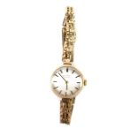 A Rotary lady's 9ct gold cased wristwatch, silvered dial with gilt batons, on a 9ct gold bracelet,