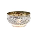 A late 19thC Chinese silver footed bowl, embossed with figures and buildings in a landscape,