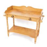 A Victorian pine washstand, with a three sided galleried top, two side towel rails raised on