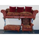 A studded red leather and tapestry Chesterfield sofa, with assorted cushions, raised on turned feet,