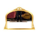 A Victorian style gilt wood over mantel mirror, with gilt foliate detailing, 92cm H, 128cm W.