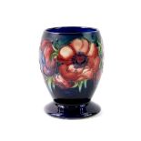A Moorcroft pottery vase, decorated in the Anemone pattern, of ovoid footed form, cobalt blue