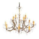 A cut glass eight branch chandelier, with a baluster stem, engraved glass drip trays and teardrop