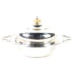 A George V silver muffin dish and cover, of twin handled form, the lid with turned ivory knop,