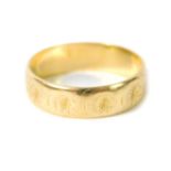 An 18ct gold wedding band, with faceted and engraved decoration, size K, 3.0g.