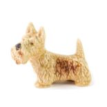 A Sylvac pottery figure of a beige standing terrier, impressed and printed marks, 16cm W.
