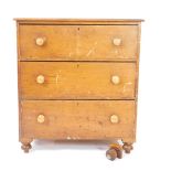 A Victorian pine chest of drawers, with three long drawers, raised on bun feet, 105.5cm H, 96cm W,