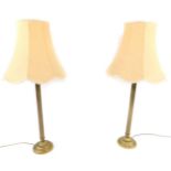 A pair of brass standard table lamps, of cast fluted form, raised on stepped circular base, with