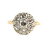 An 18ct gold and diamond daisy ring, set with seven brilliant cut diamonds, approx 1.1cts, size M,