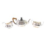 A George V silver three piece tea set, with fluted banded decoration, comprising teapot, sugar