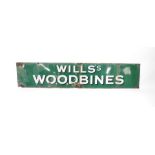 An enamel sign for Wills's Woodbine, white lettering against a green ground, 39cm H, 183cm W.