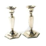 A pair of George V silver miniature candlesticks, of Adam style hexagonal baluster form,