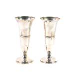 A pair of George V loaded silver vases, the central banded trumpet shape bowl raised on an