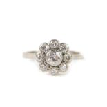 An 18ct white gold and platinum and diamond daisy ring, set with nine brilliant cut diamonds, approx