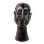 An African early 20thC ebony bust, carved as a figure, with mannerist features, 16cm H.