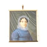 An early 19thC portrait miniature, half length study of a lady in a blue dress with lace collar