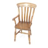 A Victorian oak and elm child's lath back Windsor chair, with solid saddle seat, raised on turned