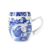 A Qing Dynasty late 18thC blue and white porcelain tankard, of barrel form, painted with river