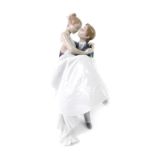 A Lladro porcelain figure modelled as The Happiest Day, printed mark, 27cm H, boxed.