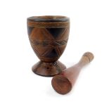 A tribal wooden pestle and mortar, with carved and stained decoration, mortar 18cm H.
