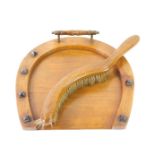 A Victorian walnut crumb tray, carved as a horseshoe, 23.5cm W, together with an oak crumb brush. (