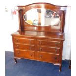 A Victorian red walnut mirror back sideboard, inset with an oval glass mirror, flanked by two turned