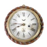 An early 20thC oak circular cased marine clock, tin dial bearing Roman numerals, subsidiary