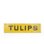 An enamel sign Fresh Cut Tulips For Sale, with raised black lettering against a yellow ground,