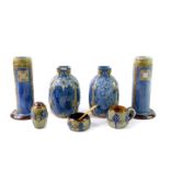 A pair of Royal Doulton stoneware vases, of cylindrical form, raised on outswept feet, decorated