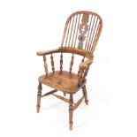 A Victorian oak and elm lathback kitchen chair, with a pierced vase shaped splat, turned spindles,