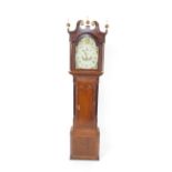 A George III mahogany and oak long case clock, the break arch dial painted with shells, thistles,