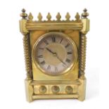 A Victorian Gothic brass mantel clock, circular dial with silver chapter ring, bearing Roman