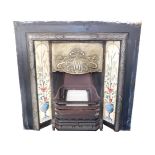 A Victorian style cast iron and brass fire place, with an Art Nouveau brass hood, embossed with