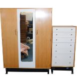 A G-Plan 1950's light oak and cream painted double wardrobe, with a mirrored central section,