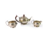 A George V silver three piece tea set, of centrally banded baluster form, comprising teapot, cream