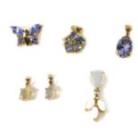 Six 9ct gold and gem set pendants, including two jelly opal pendants, tanzanite and diamond flower