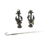 A pair of Victorian brass and enamel seals or pipe tampers, cast as furled anchors and life buoys,