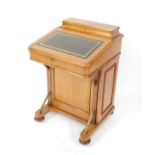 A Victorian light oak Davenport, with a fitted stationery top, hinged lid opening to reveal a burr