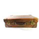 A vintage tan leather suitcase, with brass lock plates, 63cm W, 37cm D.