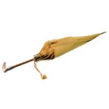 A French early 20thC tan coloured silk parasol, wooden shafted, with a silver handle, and outer