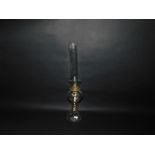 A Victorian moulded clear glass oil lamp, raised on spiral fluted stem, with chimney, 53cm H.